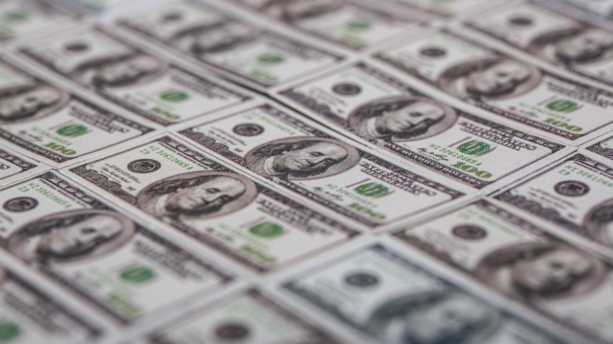 FRANCE-ILLUSTRATION-ECONOMY-2025. 100 US dollar banknotes symbols of the global economy spread out on a table in Clermont-Ferrand France on June 12 2025. (Photo by Romain Costaseca / Hans Lucas via AFP) (Photo by ROMAIN COSTASECA/Hans Lucas/AFP via Getty Images)