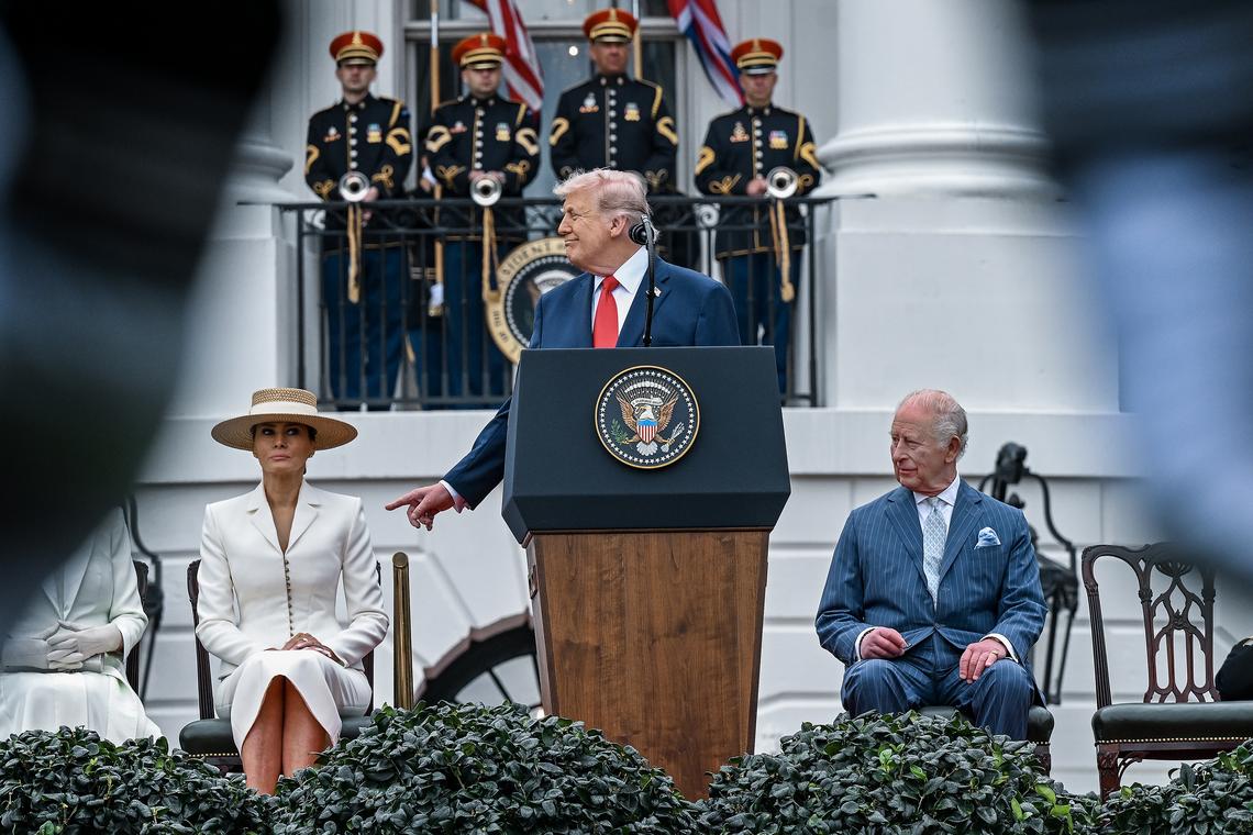 President Donald Trump speaks during an arrival ceremony for King Charles III, right, as first lady Melania Trump listens on at the South Lawn of the White House in Washington, on Tuesday, April 28, 2026. (Kenny Holston/The New York Times)