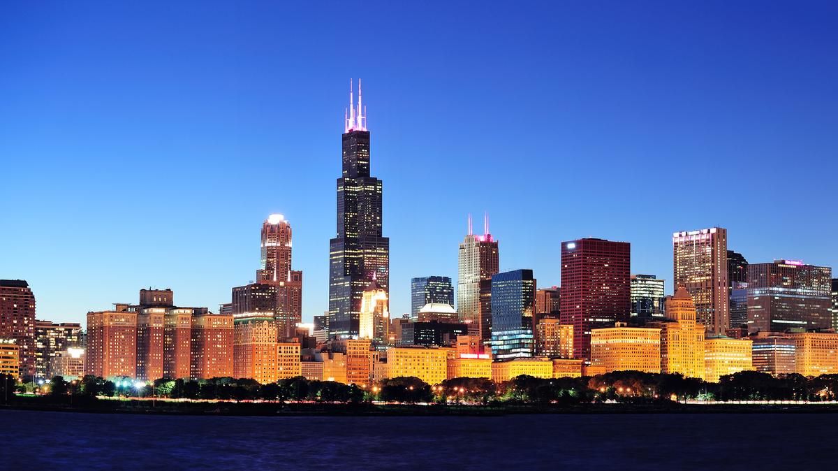 The Chicago city skyline at night, with the Willis Tower at the center. 