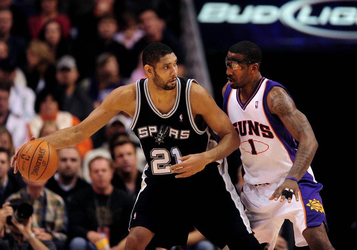  San Antonio Spurs forward Tim Duncan drives to the hoop under the defense of Phoenix Suns forward Amare Stoudemire at the US Airways Center. Mark J. Rebilas-USA TODAY Sports via Imagn Images