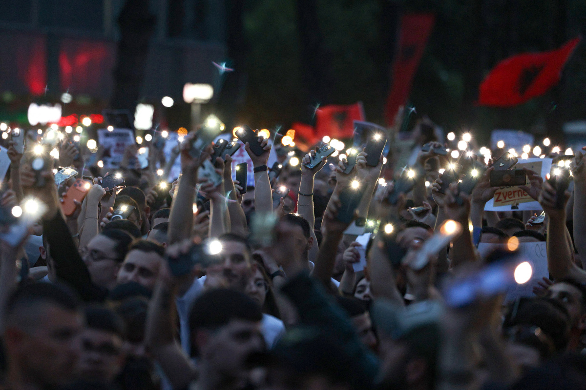 Protesters turn on their phone's lights during a protest against a luxury resort development planned by a company linked with Donald Trump's son-in-law, Jared Kushner, on an environmentally sensitive part of the Adriatic coast, in Tirana, Albania, June 4, 2026. REUTERS/Florion Goga