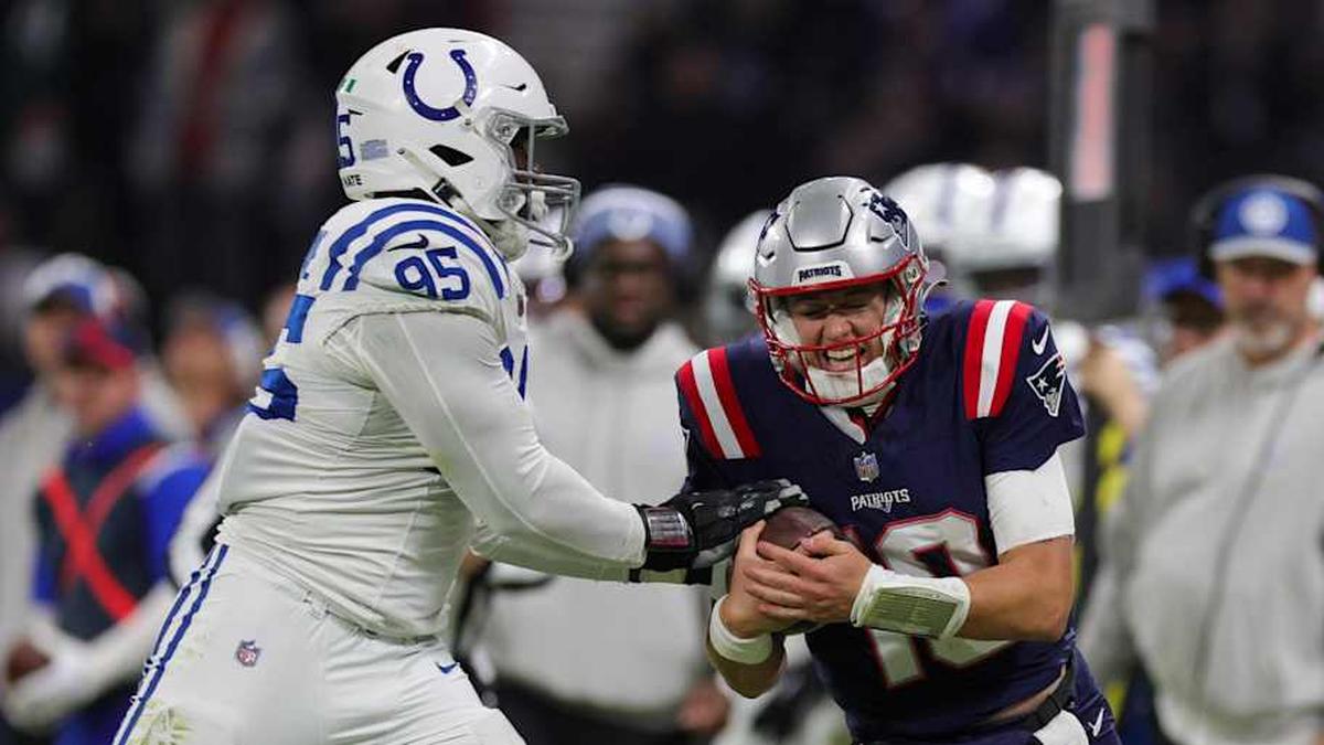  Nov 12, 2023; Frankfurt, Germany; New England Patriots quarterback Mac Jones (10) is forced out of bounds by Indianapolis Colts defensive end Adetomiwa Adebawore (95) in the third quarter during an International Series game at Deutsche Bank Park. Mandatory Credit: Nathan Ray Seebeck-Imagn Images | Nathan Ray Seebeck-Imagn Images 