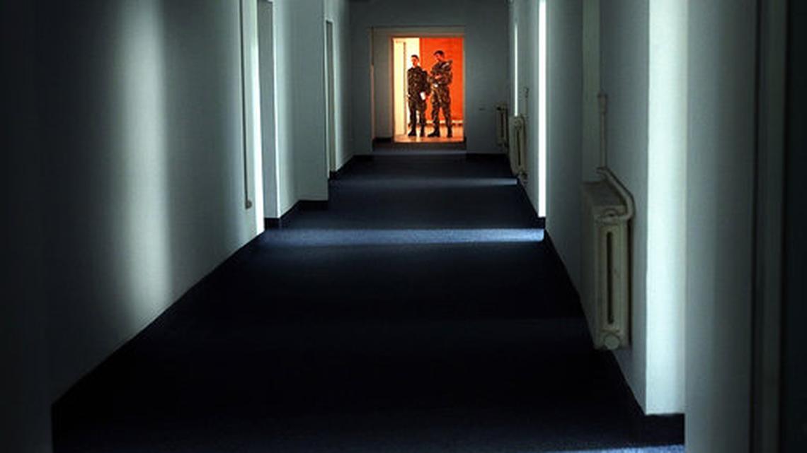 In this Wednesday, Nov. 9, 2005, file picture Romanian military staff stand at the end of a corridor on the Mihail Kogalniceanu airbase, near the Black Sea port of Constanta, Romania, a Soviet-era facility which became a key focus of a European investigation into allegations that the CIA operated secret prisons. The European Court of Human Rights has ruled, Thursday, May 31, 2018, that Romania and Lithuania allowed the detention and abuse of a Saudi national and a Palestinian national, saying that Abd al Rahim Al Nashiri was detained and abused in Romania between Sept. 2003 and Oct. 2005 and urging Romania to investigate and punish perpetrators.