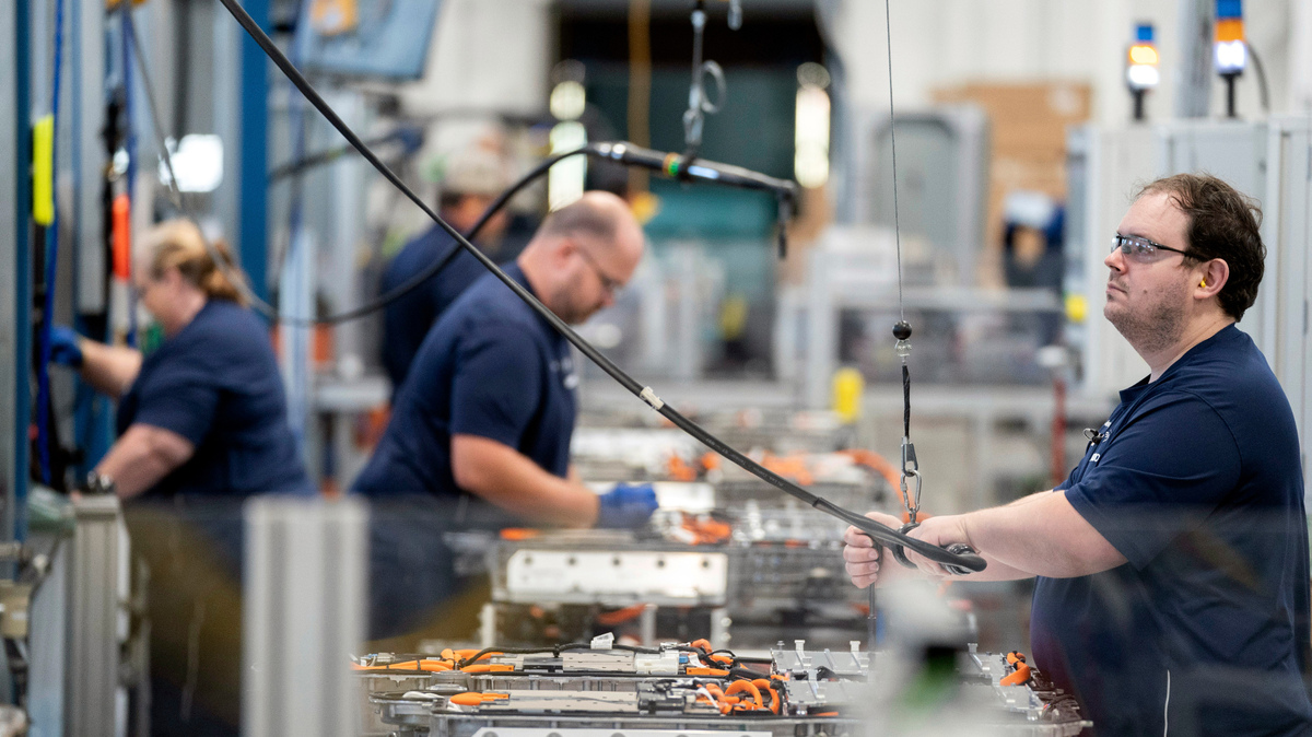 Employees work in the battery assembly hall at the BMW Spartanburg plant in Greer, S.C., Wednesday, Oct. 19, 2022. BMW’s sprawling factory near Spartanburg, will get a $1 billion investment, and the German automaker will spend another $700 million to build a battery plant nearby as it begins the transition to electric vehicles in the U.S., the company announced. (AP Photo/Sean Rayford)
