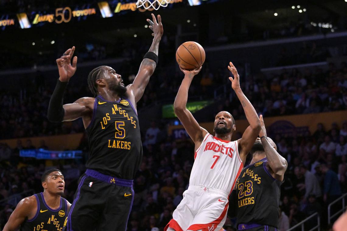  Apr 21, 2026; Los Angeles, California, USA; Houston Rockets forward Kevin Durant (7) is defended by Los Angeles Lakers center Deandre Ayton (5) as he drives to the basket during the second half of game two of the first round of the 2026 NBA Playoffs at Crypto.com Arena. Mandatory Credit: Jayne Kamin-Oncea-Imagn Images 