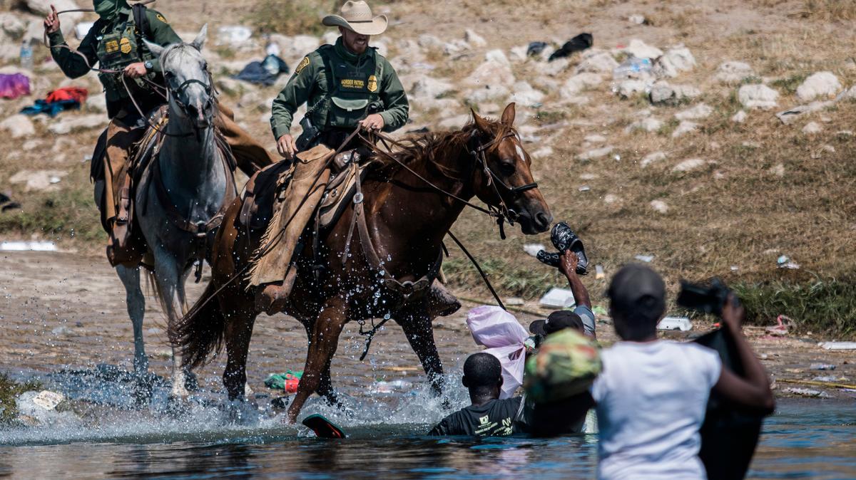 File photo shows mounted U.S. Border Patrol agents attempting to stop Black migrants crossing the border into Texas in September.