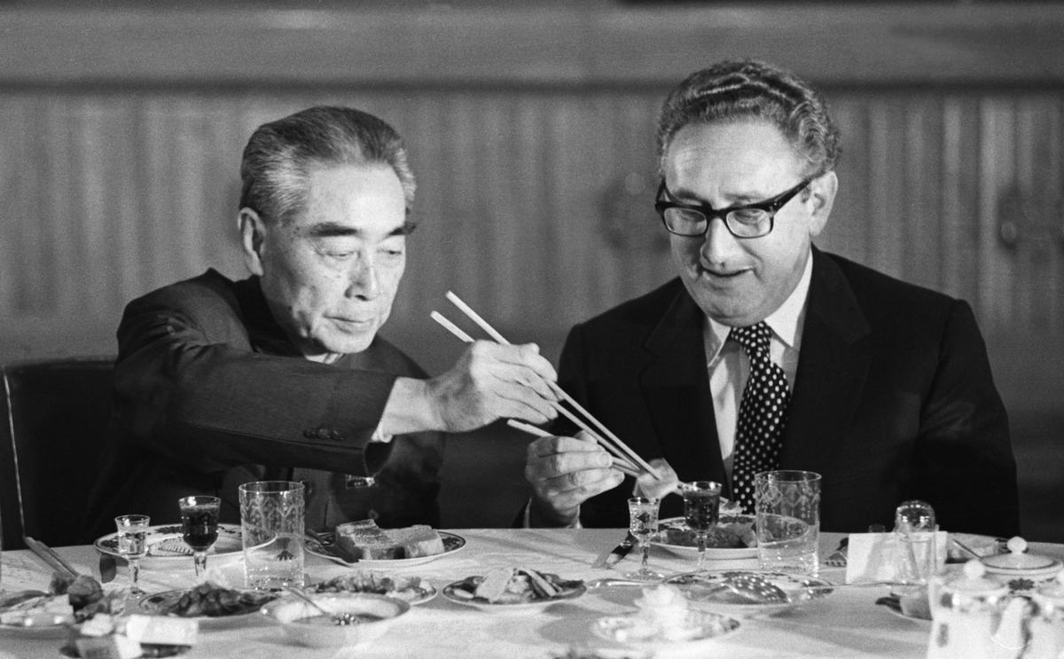 Henry Kissinger accepts food from Chinese Premier Zhou Enlai during a state banquet in the Great Hall of the People in Beijing in 1973. Bettman/Getty Images 