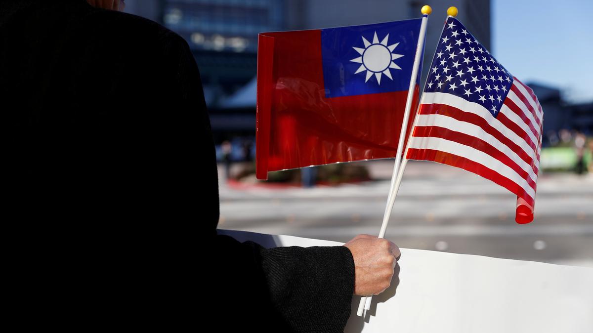 FILE PHOTO: A man holds the flags of Taiwan and the United States during Taiwanese President Tsai Ing-wen's stopover after her visit to Latin America, in Burlingame, California, U.S., January 14, 2017. REUTERS/Stephen Lam/File Photo