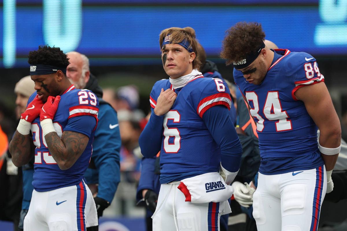  Dec 14, 2025; East Rutherford, New Jersey USA; (l-r) New York Giants running back Tyrone Tracy Jr. (29) and quarterback Jaxson Dart (6) and tight end Theo Johnson (84) during the National anthem prior to the first quarter against the Washington Commanders at MetLife Stadium. Mandatory Credit: Vincent Carchietta-Imagn Images 