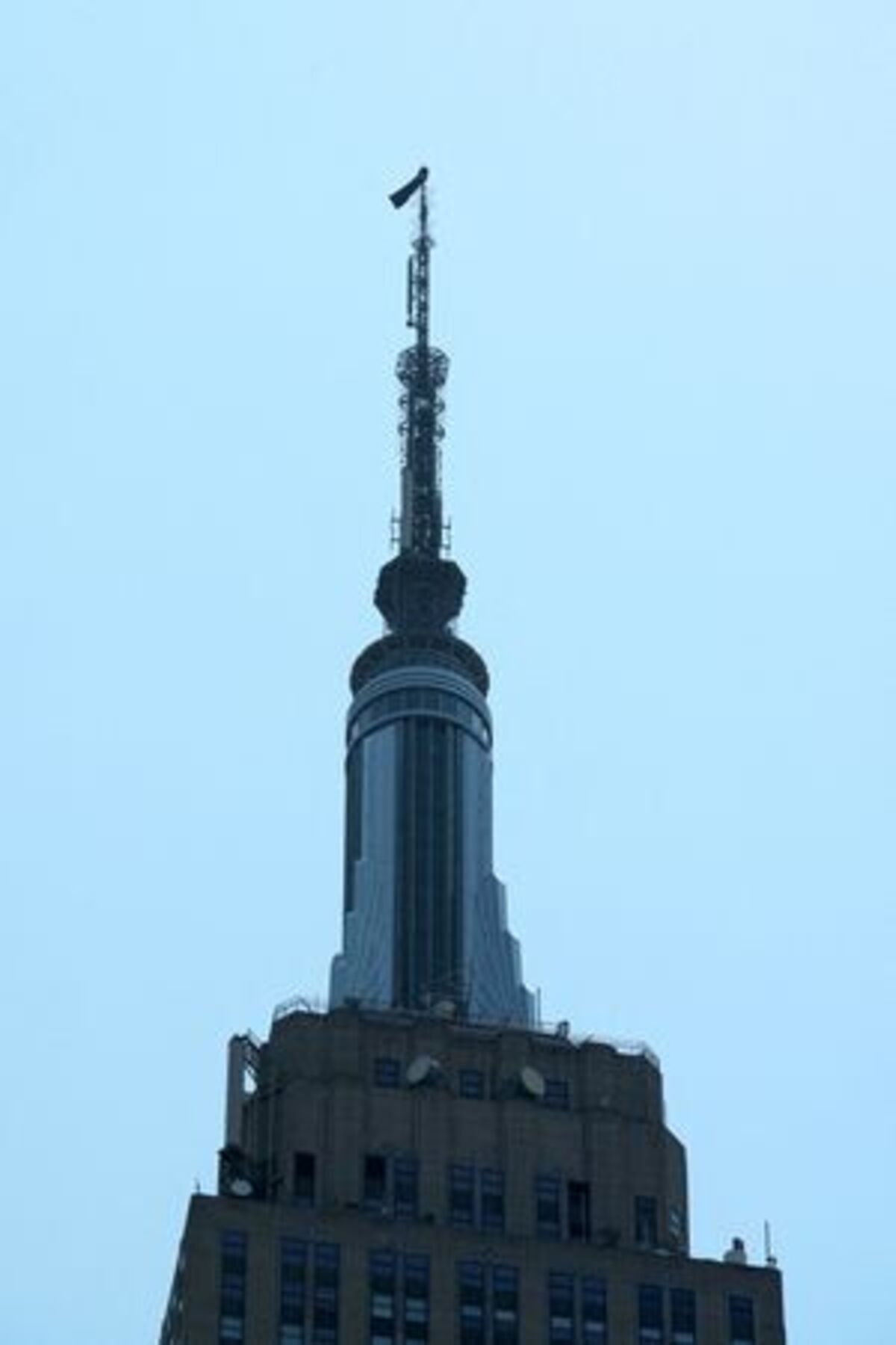 Two people display a banner as they stage a protest atop the Empire State Building in the Manhattan borough of New York, U.S., July 1, 2026.  REUTERS/Adam Gray
