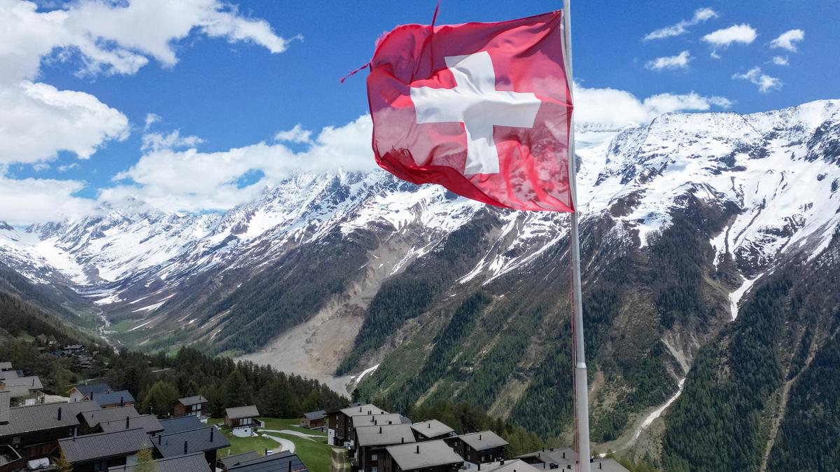 A drone view shows the village of Wiler, overlooking the landslide area nearly a year after a massive rock and ice slide triggered by the collapse of the Birch Glacier destroyed much of the village of Blatten, Switzerland, May 13, 2026. REUTERS/Denis Balibouse