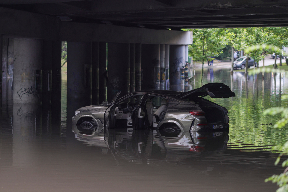 A car is stranded in the middle of a flooded railway underpass in northern Bucharest, Romania, July 1, 2026. Inquam Photos/Octav Ganea via REUTERS