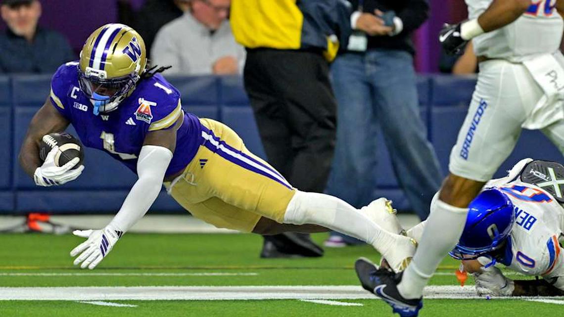  Dec 13, 2025; Inglewood, CA, USA; Washington Huskies running back Jonah Coleman (1) is stopped short of the goal line by Boise State Broncos defensive back Ty Benefield (0) in the first half of the LA Bowl at SoFi Stadium. Mandatory Credit: Jayne Kamin-Oncea-Imagn Images | Jayne Kamin-Oncea-Imagn Images 