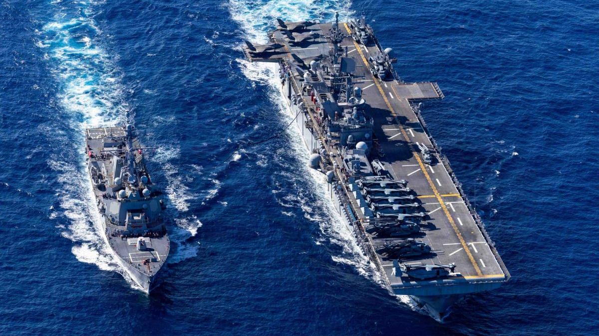 U.S. Navy Arleigh Burke-class guided-missile destroyer USS Rafael Peralta, left, receives fuel in February from America-class amphibious assault ship USS Tripoli during a replenishment-at-sea in the Philippine Sea. The Rafael Peralta is one of the warships allegedly attacked by Iranian missile and drone attacks Thursday. U.S. Navy photo by Mass Communication Specialist 1st Class Ryre Arciaga