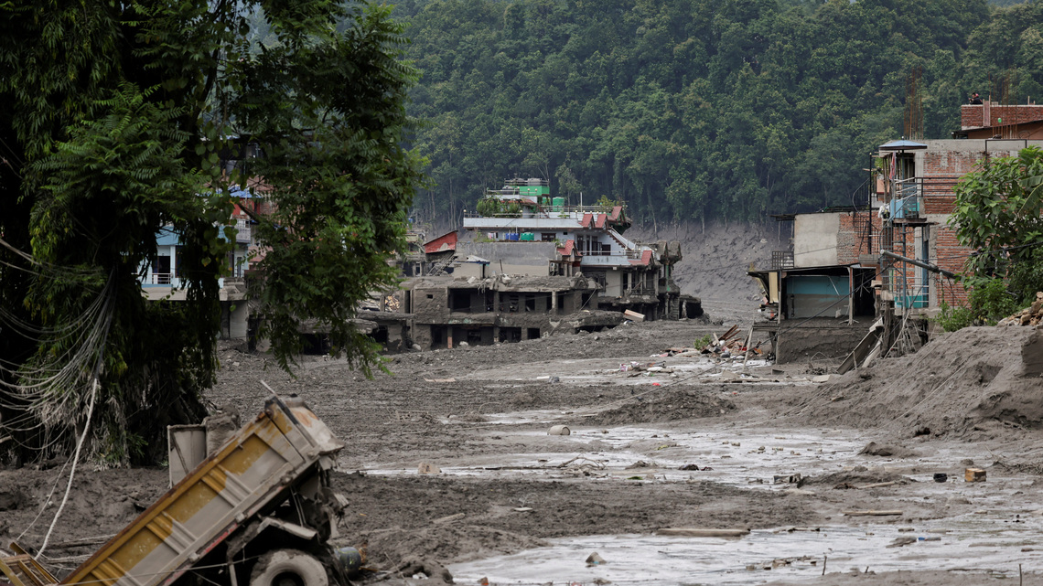 What triggered the catastrophic flood on the Nepal-Tibet border?
