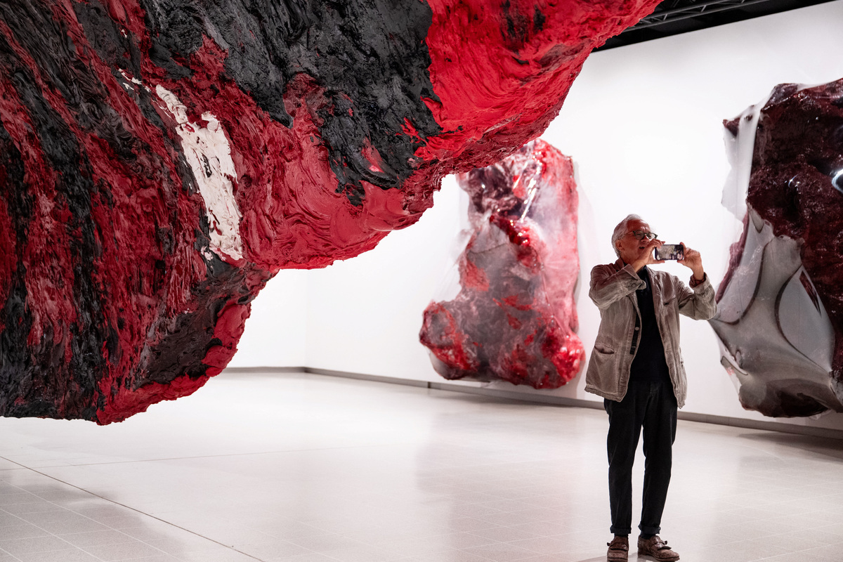 British-Indian sculptor Anish Kapoor poses for a photograph next to his installation 'Mount Moriah at the Gate of the Ghetto' (2022) during the press view for 'Anish Kapoor' at the Hayward Gallery, in London, Britain, June 15, 2026. REUTERS/Chris J. Ratcliffe