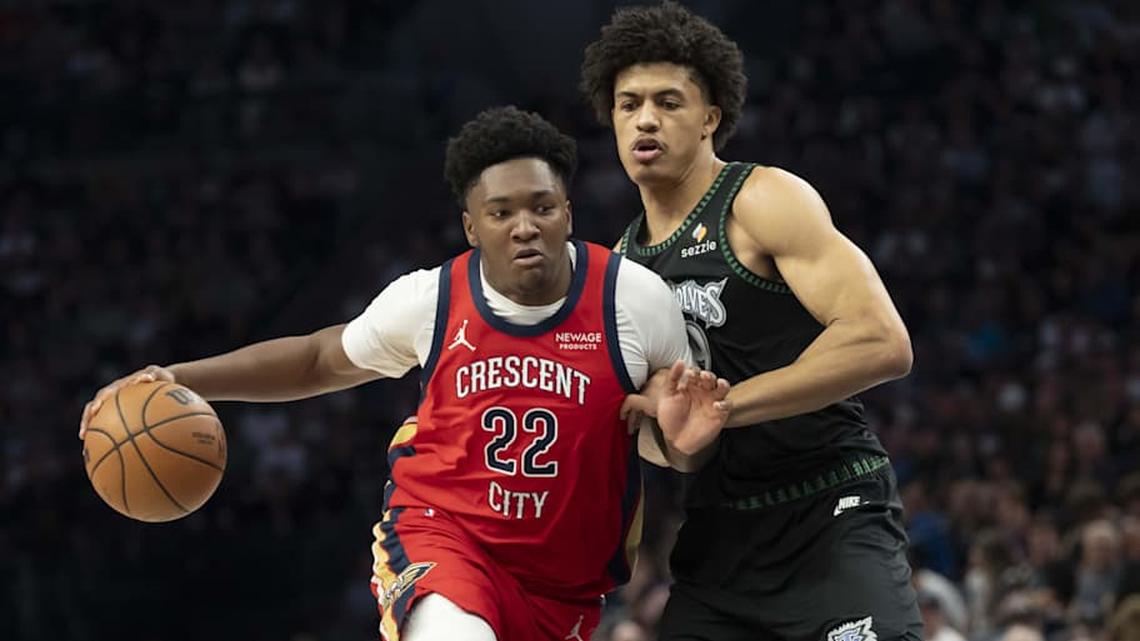  Apr 12, 2026; Minneapolis, Minnesota, USA; New Orleans Pelicans center Derik Queen (22) dribbles past Minnesota Timberwolves forward Joan Beringer (19) in the first half at Target Center. Mandatory Credit: Jesse Johnson-Imagn Images | Jesse Johnson-Imagn Images 