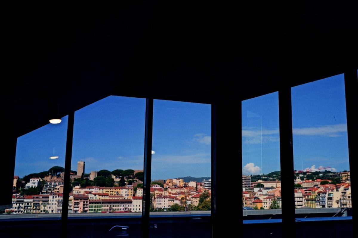 The Suquet district is seen through windows at the Palais des Festivals during the 79th Cannes Film Festival in Cannes, France, May 18, 2026. REUTERS/Manon Cruz