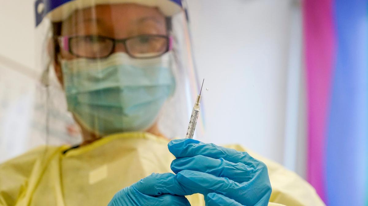 File photo of a physician assistant preparing a syringe on Aug. 19 in New York.