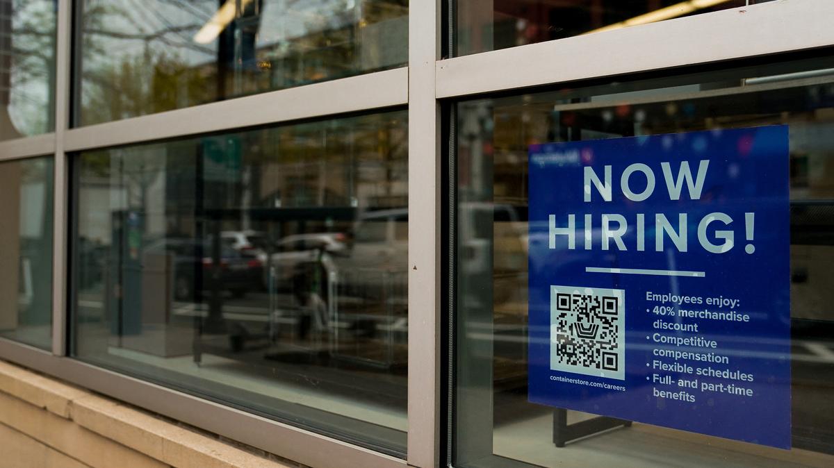 An employee hiring sign with a QR code is seen in a window of a business in Arlington, Virginia, U.S., April 7, 2023. REUTERS/Elizabeth Frantz/File Photo