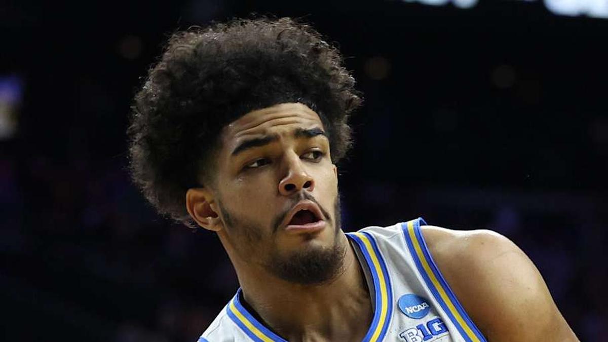  Mar 20, 2026; Philadelphia, PA, USA; UCLA Bruins guard Eric Freeny (8) makes a pass against UCF Knights center John Bol (7) in the second half during a first round game of the men's 2026 NCAA Tournament at Xfinity Mobile Arena. Mandatory Credit: Bill Streicher-Imagn Images | Bill Streicher-Imagn Images 