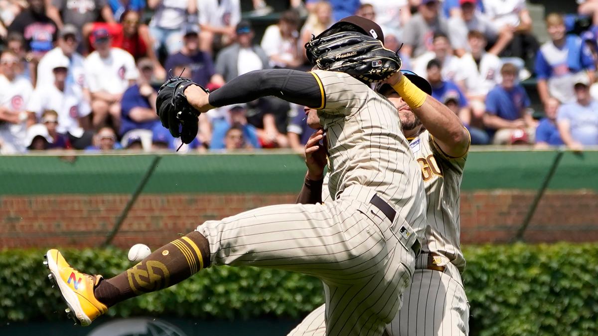 San Diego Padres’ Ha-Seong Kim, foreground, and Tommy Pham collide going after a fly ball hit by Chicago Cubs’ P.J. Higgins in the fourth inning of a baseball game Wednesday, June 2, 2021, in Chicago. (AP Photo/Charles Rex Arbogast)