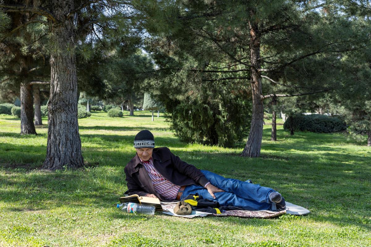 A man reads his book as he enjoys a sunny day at a park in Ashgabat, Turkmenistan, March 20 2026. REUTERS/Umit Bektas