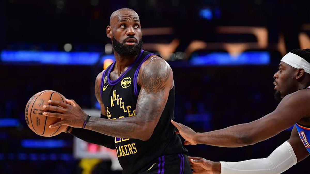  Lakers forward LeBron James controls the ball against Thunder guard Luguentz Dort. | Gary A. Vasquez-Imagn Images 