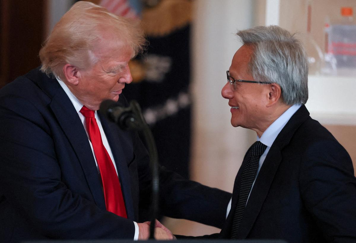 FILE PHOTO: NVIDIA CEO Jensen Huang and U.S. President Donald Trump shake hands at an 'Investing in America' event in Washington, D.C., U.S., April 30, 2025. REUTERS/Leah Millis/File Photo
