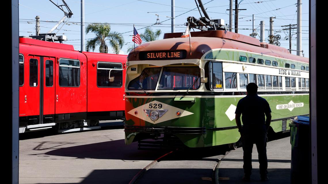 MTS project coordinator Alfonso Florian stands next to a restored 1946 Presidents Conference Committee (PCC) streetcar and the first red San Diego Trolley, the 1001, which are part of the Silver Line's vintage vehicles fleet, on March 9, 2026, in San Diego. (K.C. Alfred/The San Diego Union-Tribune/TNS)