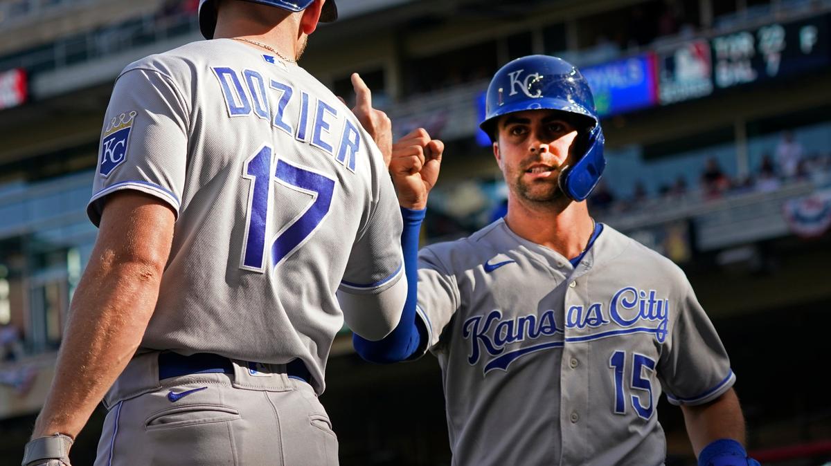 Kansas City Royals Whit Merrifield (15) fist-bumps Hunter Dozier after Merrifield scored on a Andrew Benintendi sacrifice fly off Minnesota Twins pitcher Juan Minaya in the ninth inning of a baseball game, Sunday, Sept. 12, 2021, in Minneapolis. The Royals won 5-3. (AP Photo/Jim Mone)