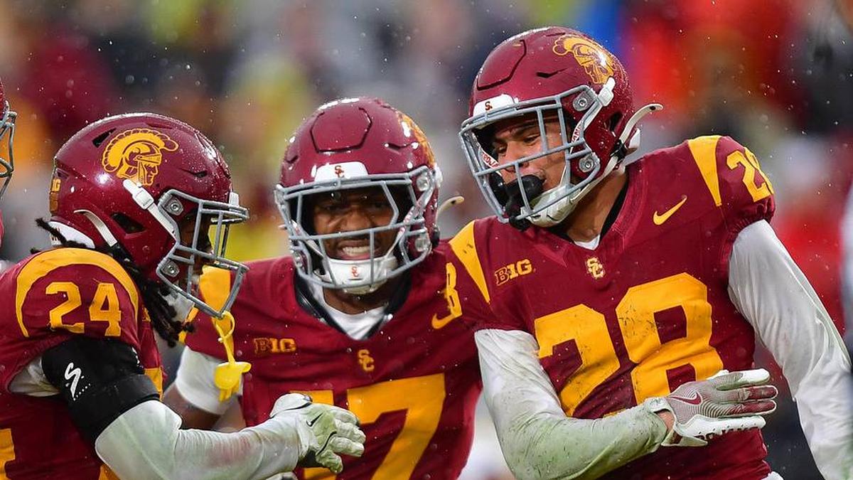  Nov 15, 2025; Los Angeles, California, USA; Southern California Trojans cornerback Alex Graham (27) safety Christian Pierce (24) cornerback Decarlos Nicholson (17) and safety Kennedy Urlacher (28) celebrate after Iowa Hawkeyes turn the ball over on fourth down during the second half at the Los Angeles Memorial Coliseum. Mandatory Credit: Gary A. Vasquez-Imagn Images | Gary A. Vasquez-Imagn Images 