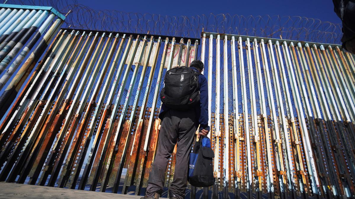 A migrant waits on the Mexican side of the U.S. border in Tijuana, Mexico on Jan. 26.