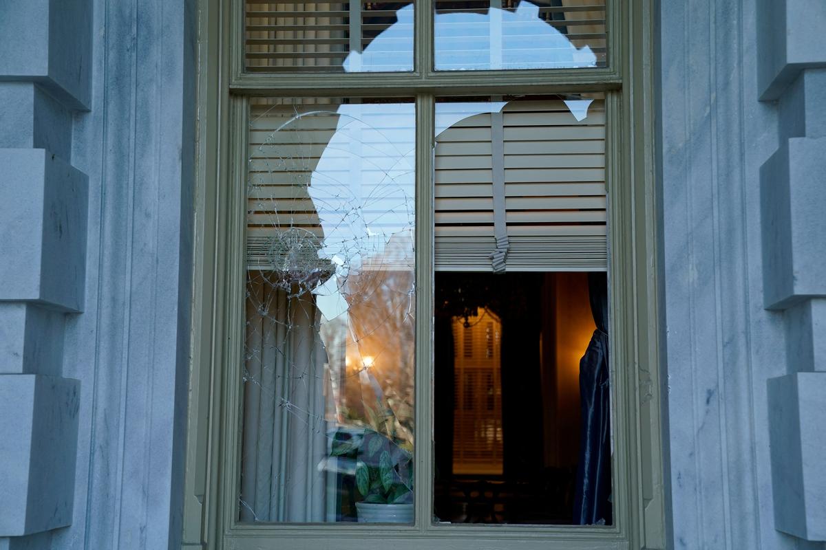 FILE PHOTO: A U.S. Capitol window is seen smashed a day after supporters of U.S. President Donald Trump stormed the Capitol in Washington, U.S., January 7, 2021. REUTERS/Erin Scott/File Photo