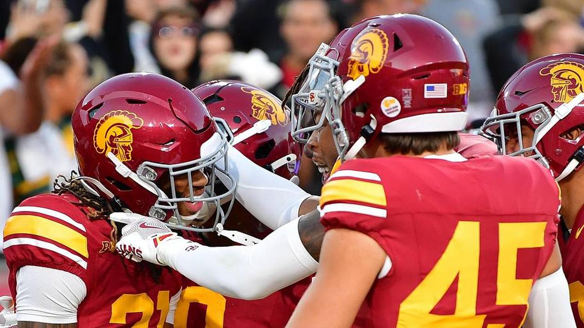  Nov 16, 2024; Los Angeles, California, USA; Southern California Trojans cornerback Greedy Vance Jr. (21) celebrates after intercepting a pass against Nebraska Cornhuskers quarterback Dylan Raiola (15) for the game victory at the Los Angeles Memorial Coliseum. Mandatory Credit: Gary A. Vasquez-Imagn Images | Gary A. Vasquez-Imagn Images 
