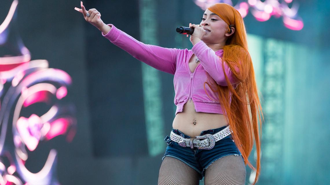 The “Barbie World” rapper performs in Miami while wearing a pink cropped jacket, mesh tights and jean shorts on stage at Hard Rock Stadium.