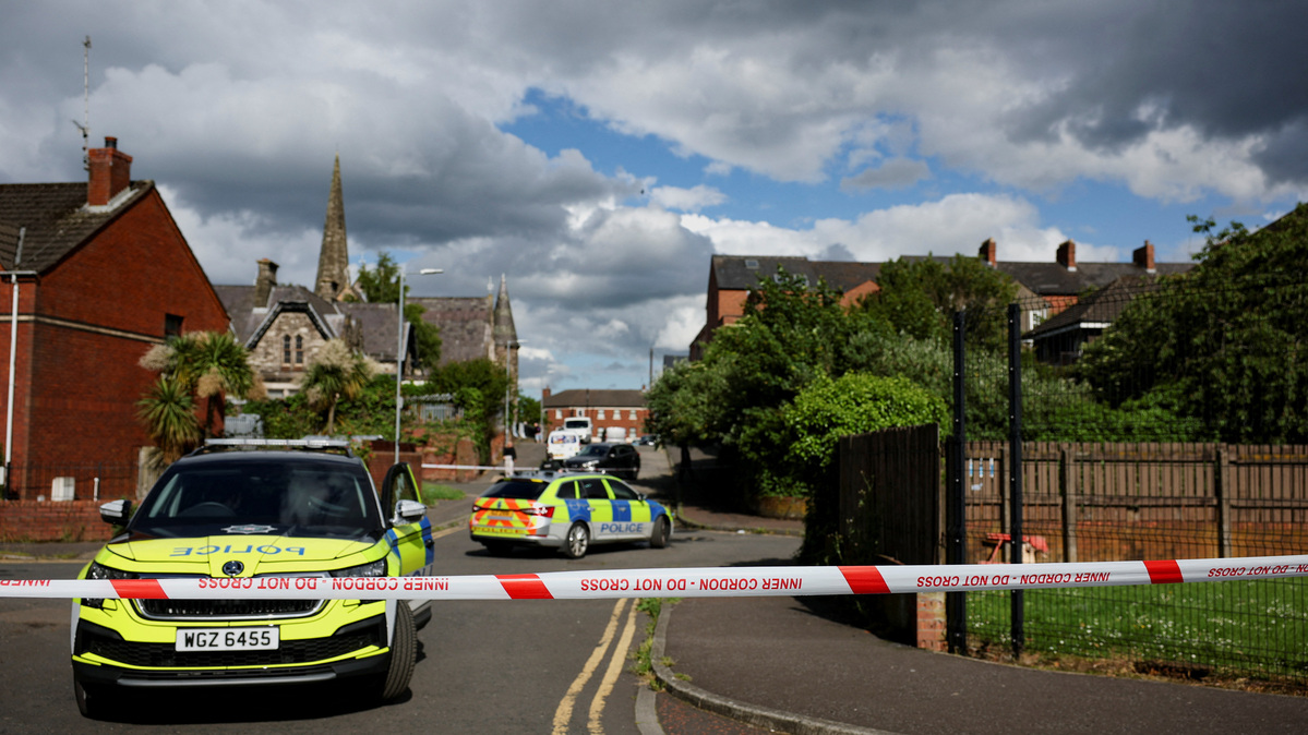 Police vehicles sit near a cordon at the scene of a stabbing outside apartments in the Kinnaird Avenue area of north Belfast, after a knife attack on June 8 left a man seriously injured and prompted police to declare a critical incident, in Belfast, Northern Ireland, June 9, 2026. REUTERS/Isabel Infantes