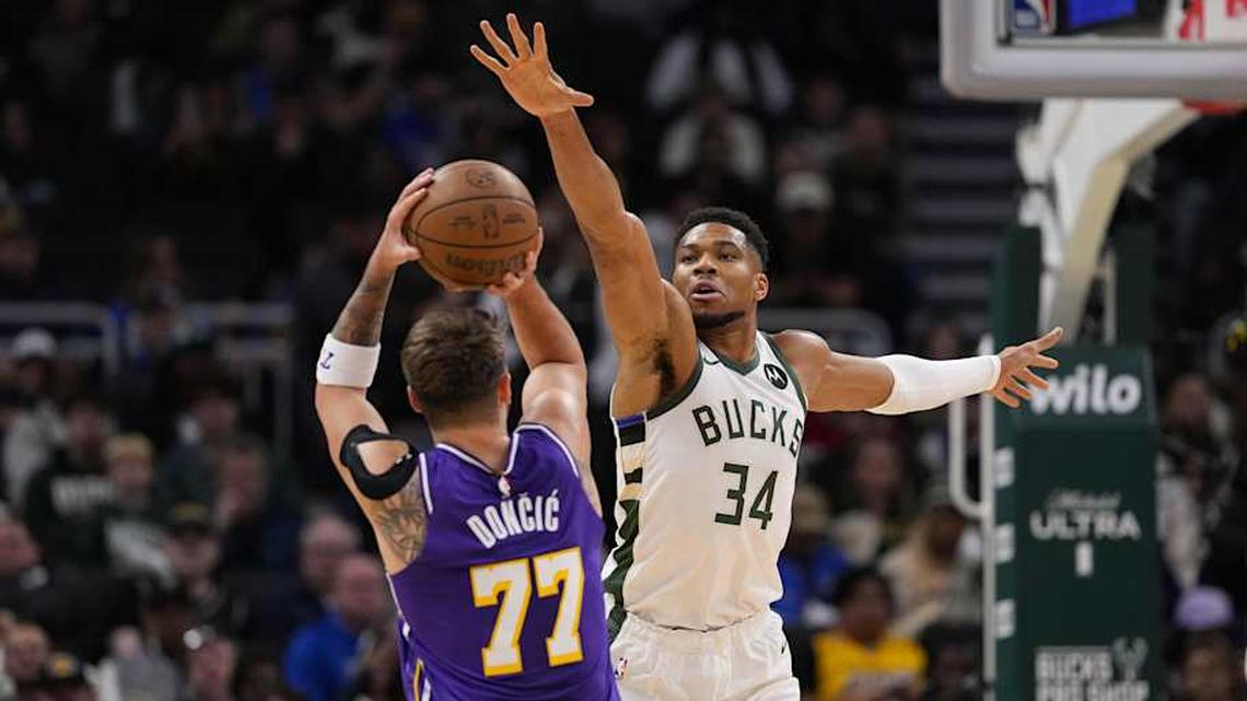  Nov 15, 2025; Milwaukee, Wisconsin, USA; Milwaukee Bucks forward Giannis Antetokounmpo (34) defends Los Angeles Lakers guard Luka Doncic (77) during the first quarter at Fiserv Forum. Mandatory Credit: Jeff Hanisch-Imagn Images | Jeff Hanisch-Imagn Images 