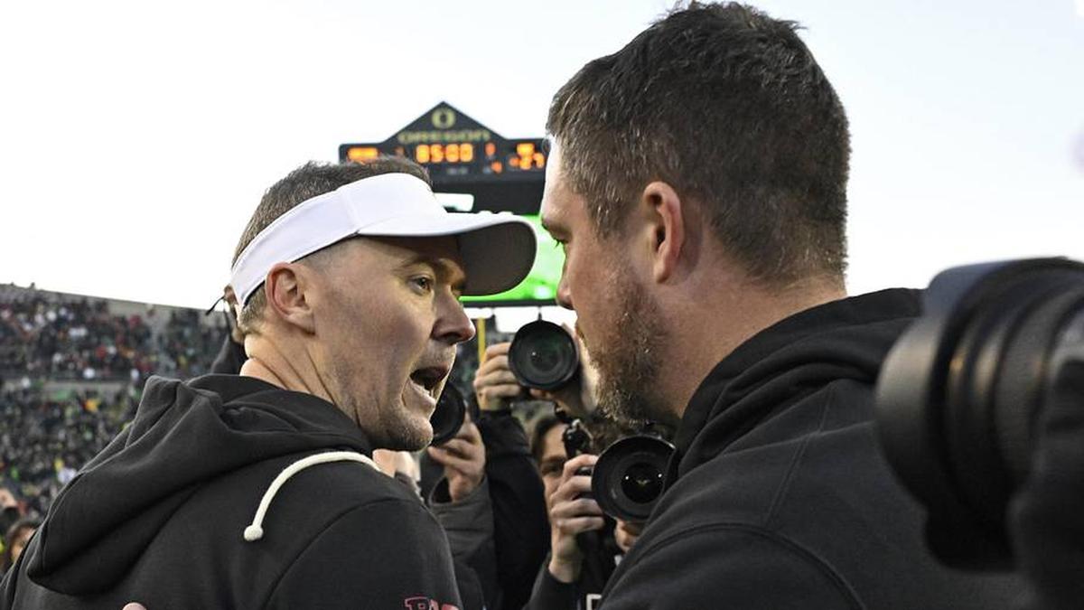  Nov 22, 2025; Eugene, Oregon, USA; Southern California Trojans head coach Lincoln Riley and Oregon Ducks head coach Dan Lanning greet each other after the game at Autzen Stadium. Mandatory Credit: Troy Wayrynen-Imagn Images | Troy Wayrynen-Imagn Images 