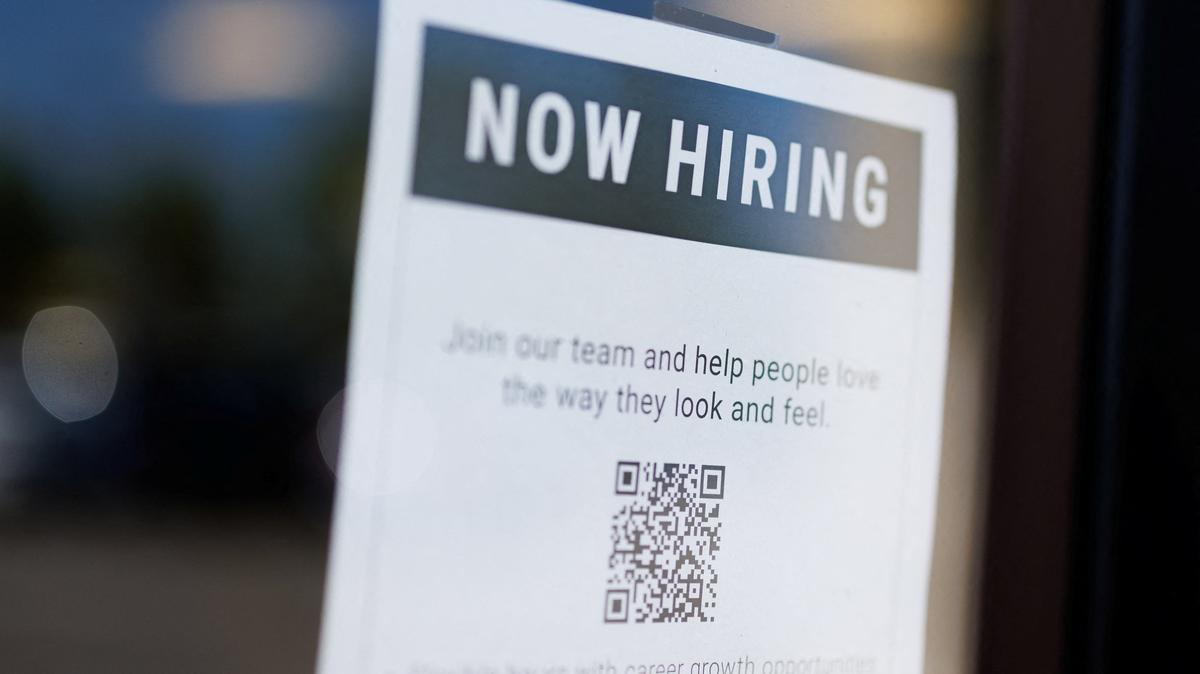 A "now hiring" sign is displayed on a local business after, U.S. employment growth slowed more than expected in July, in Encinitas, California, U.S. August 1, 2025.   REUTERS/Mike Blake