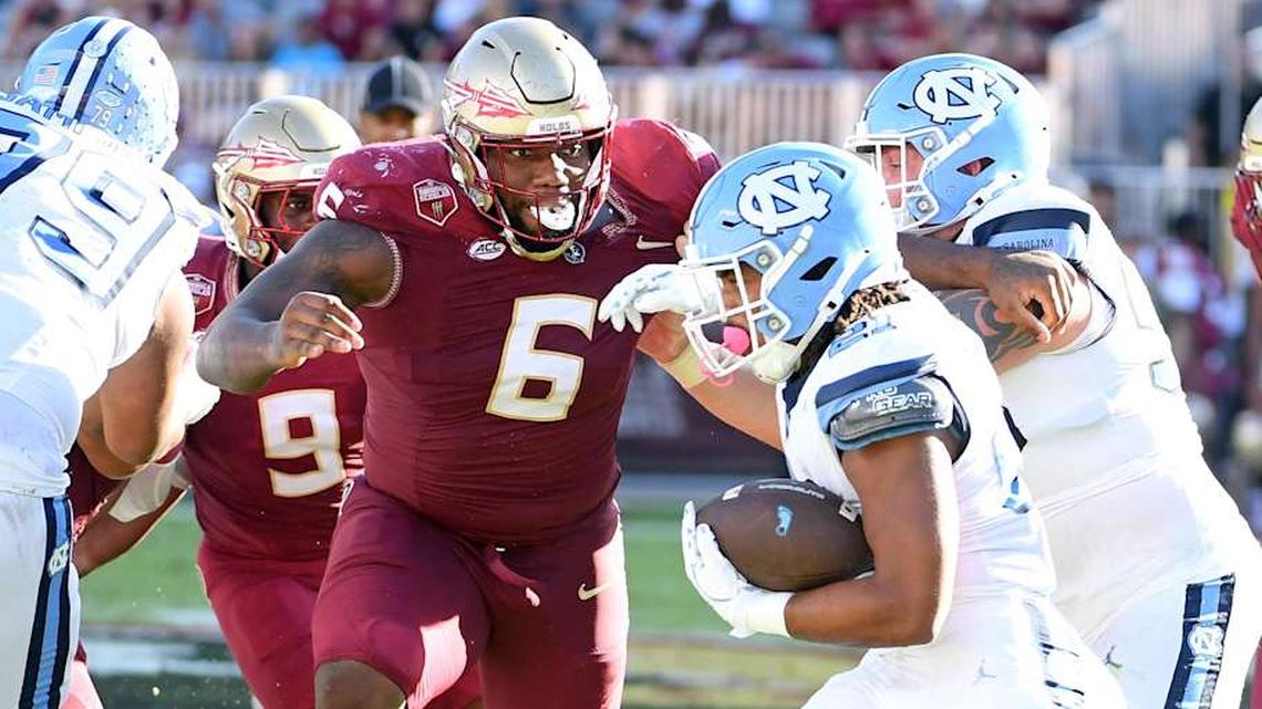  Nov 2, 2024; Tallahassee, Florida, USA; Florida State Seminoles defensive tackle Darrell Jackson Jr (6) pursues North Carolina Tarheels running back Davion Gause (21) in the second quarter at Doak S. Campbell Stadium. Mandatory Credit: Robert Myers-Imagn Images | Robert Myers-Imagn Images 
