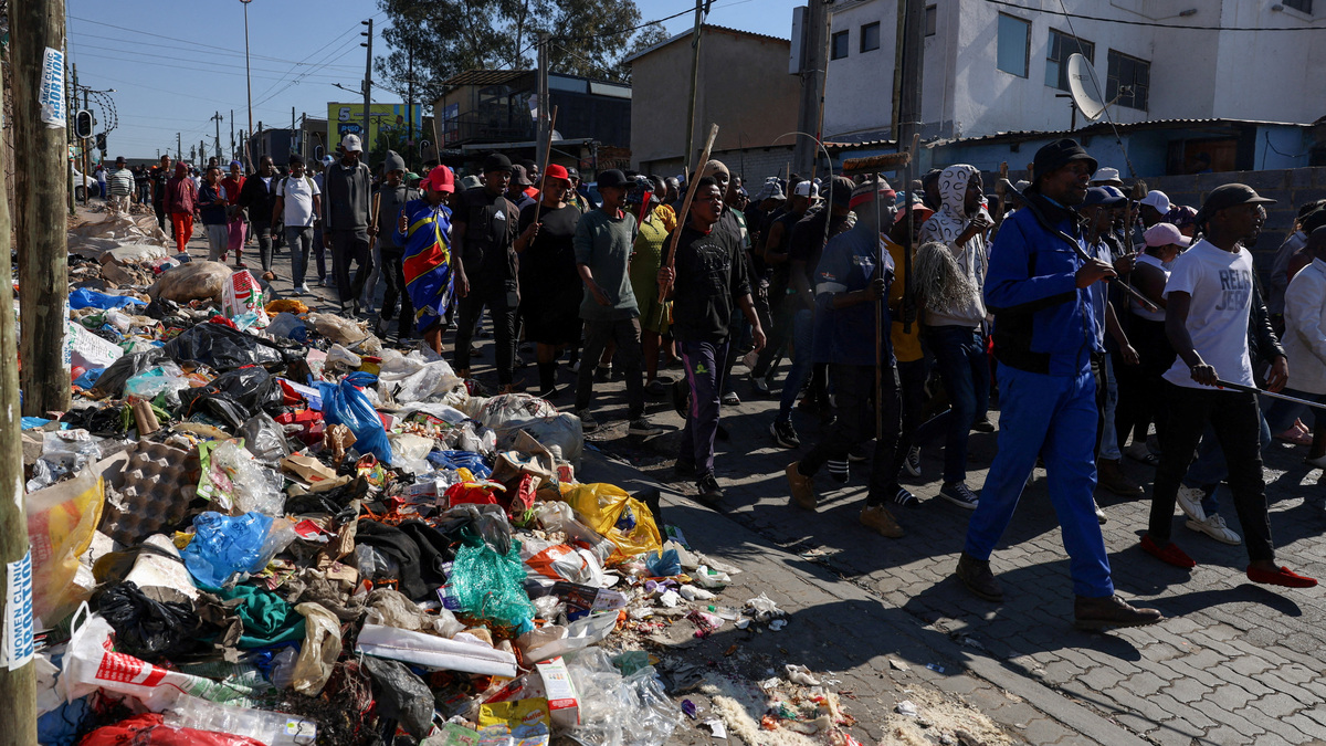 People march as anti-immigrant protesters go door-to-door in search of undocumented foreign nationals to take them to the police, after an unofficial June 30 deadline set by anti-immigrant groups for undocumented migrants to leave the country had passed, in Alexandra township, South Africa, July 9, 2026. REUTERS/Oupa Nkosi
