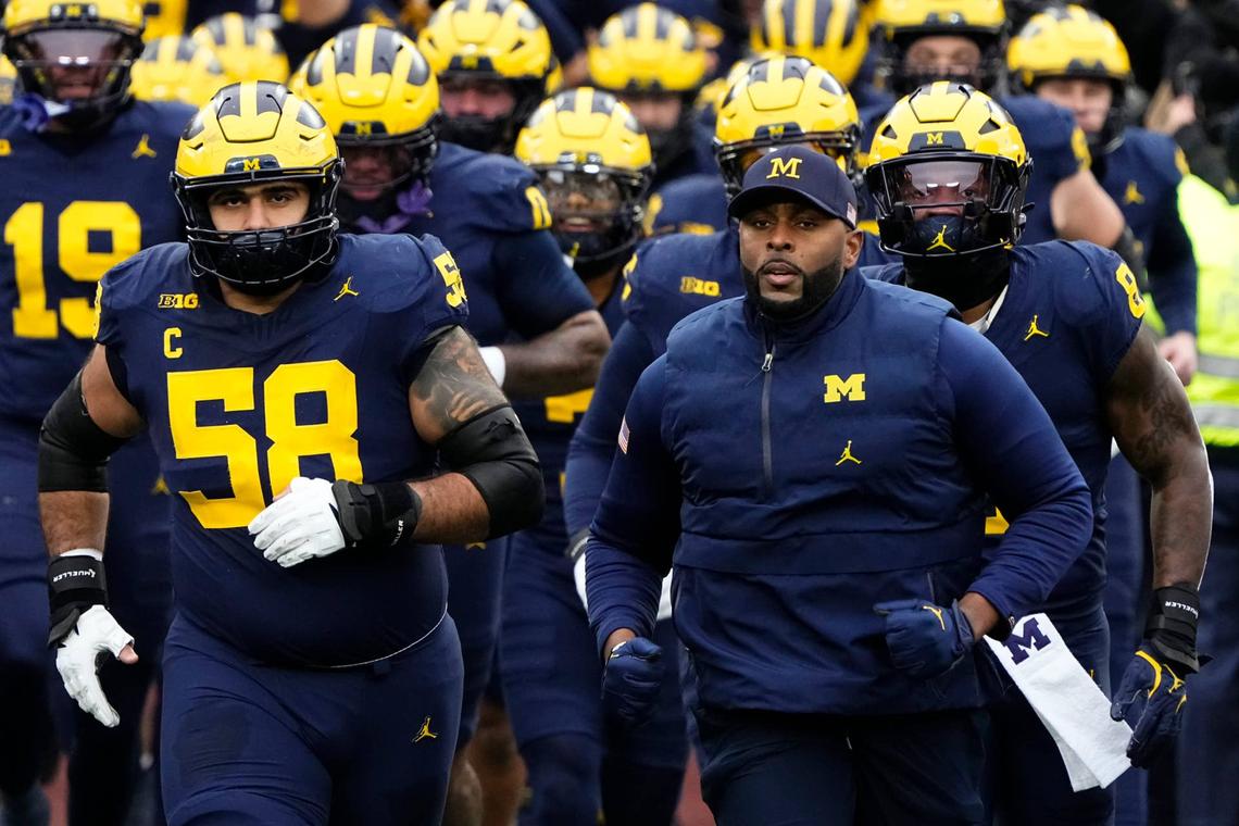  Michigan Wolverines head coach Sherrone Moore leads his team onto the field prior to the NCAA football game against the Ohio State Buckeyes at Michigan Stadium in Ann Arbor, Mich. on Nov. 29, 2025. 