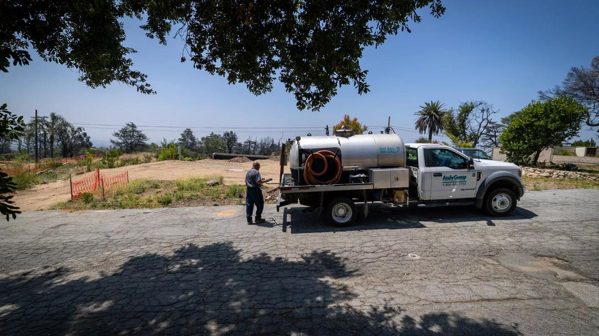 A worker pumps sewage from a portable toilet on the property of Morgan Whirledge, who is in the initial stages of rebuilding at his Altadena lot. Allen J. Schaben/Los Angeles Times/TNS)
