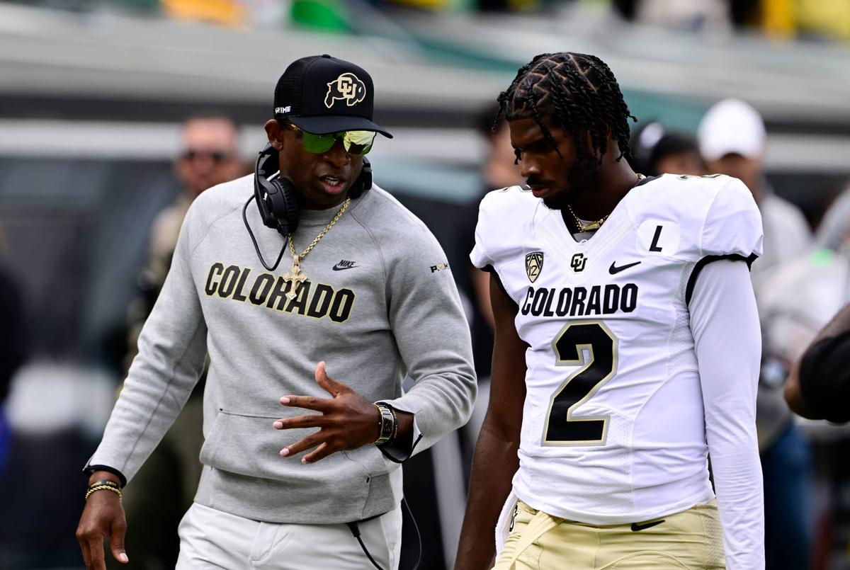  Colorado Buffaloes head coach Deion Sanders talks with his son QB Shedeur Sanders before the game against the Oregon Ducks at Autzen Stadium September 23, 2023. 