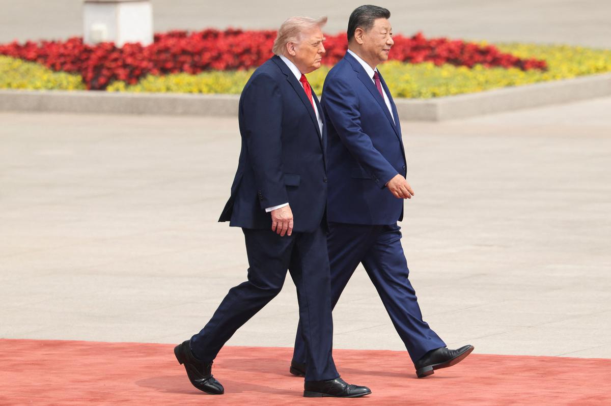 Chinese President Xi Jinping walks with U.S. President Donald Trump during a welcome ceremony at the Great Hall of the People, in Beijing, China, May 14, 2026. REUTERS/Maxim Shemetov/Pool