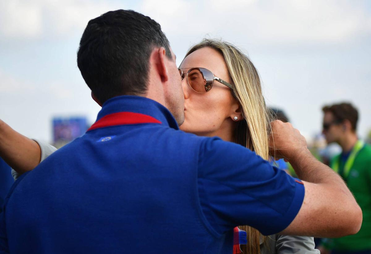  PARIS, FRANCE - SEPTEMBER 28: Rory McIlroy of Europe and wife Erica McIlroy share a kiss during the afternoon foursome matches of the 2018 Ryder Cup at Le Golf National on September 28, 2018 in Paris, France. (Photo by Stuart Franklin/Getty Images) 