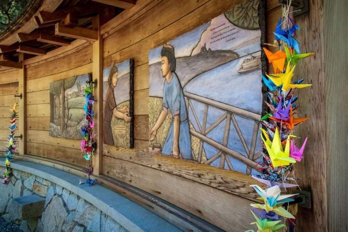 The historic cedar wall stands as a moving tribute at the memorial site. Photo credit: June Russell-Chamberlin 