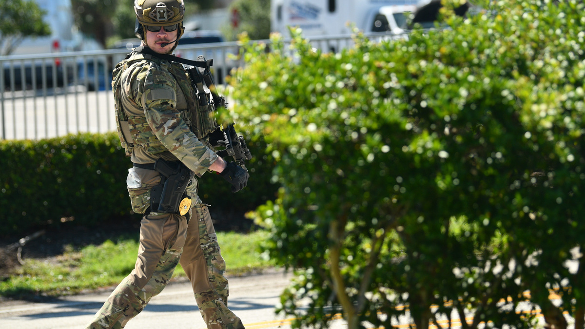 A police officer in tactical gear approaches the kava bar in a shopping center at 625 N. Atlantic Ave. in Cocoa Beach.