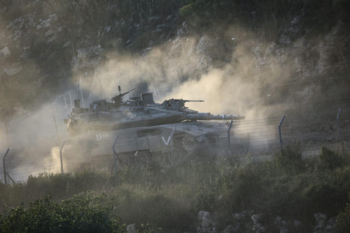  An Israeli military tank drives along the Israeli-Lebanese border. Gil Cohen-Magen/Picture Alliance via Getty Images 